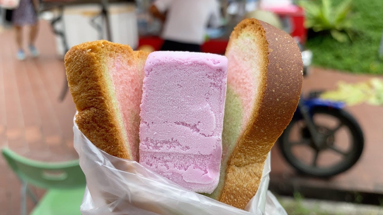 Pink ice cream between slices of rainbow bread