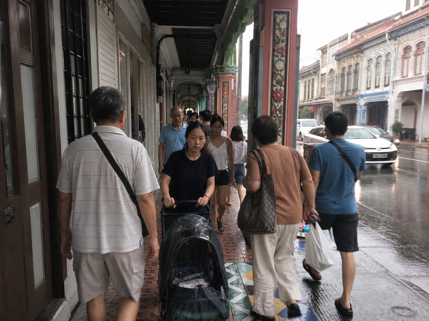 Pedestrians passing on a narrow five-foot way in Joo Chiat