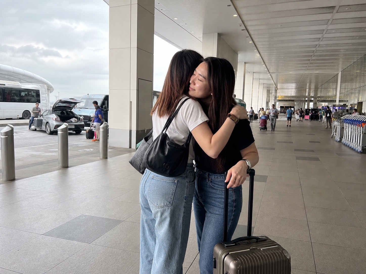 Friends saying goodbye with a suitcase at Changi Airport
