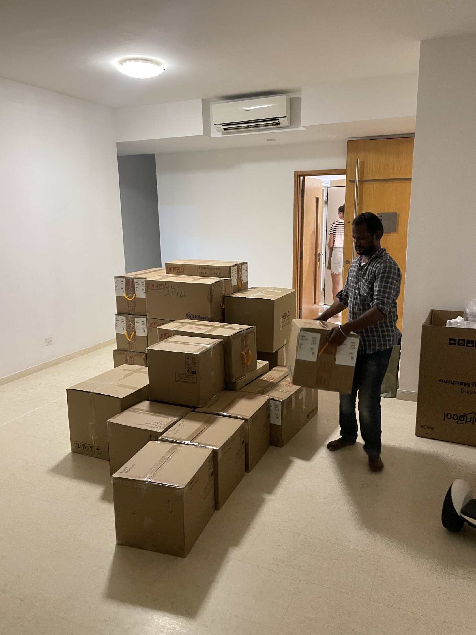 The mountain of boxes and one of the movers.