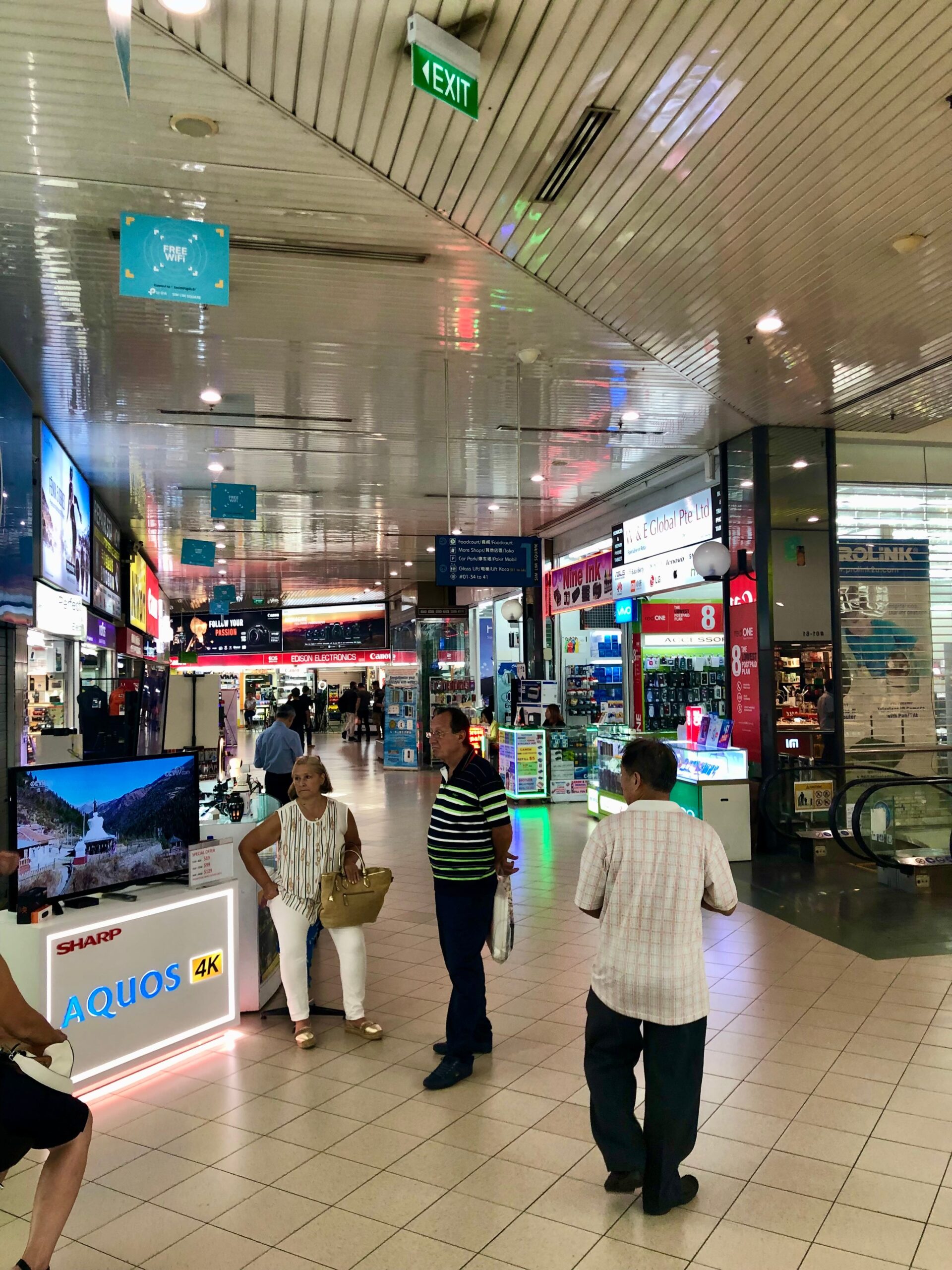 Shoppers browsing electronics stores at Sim Lim Square