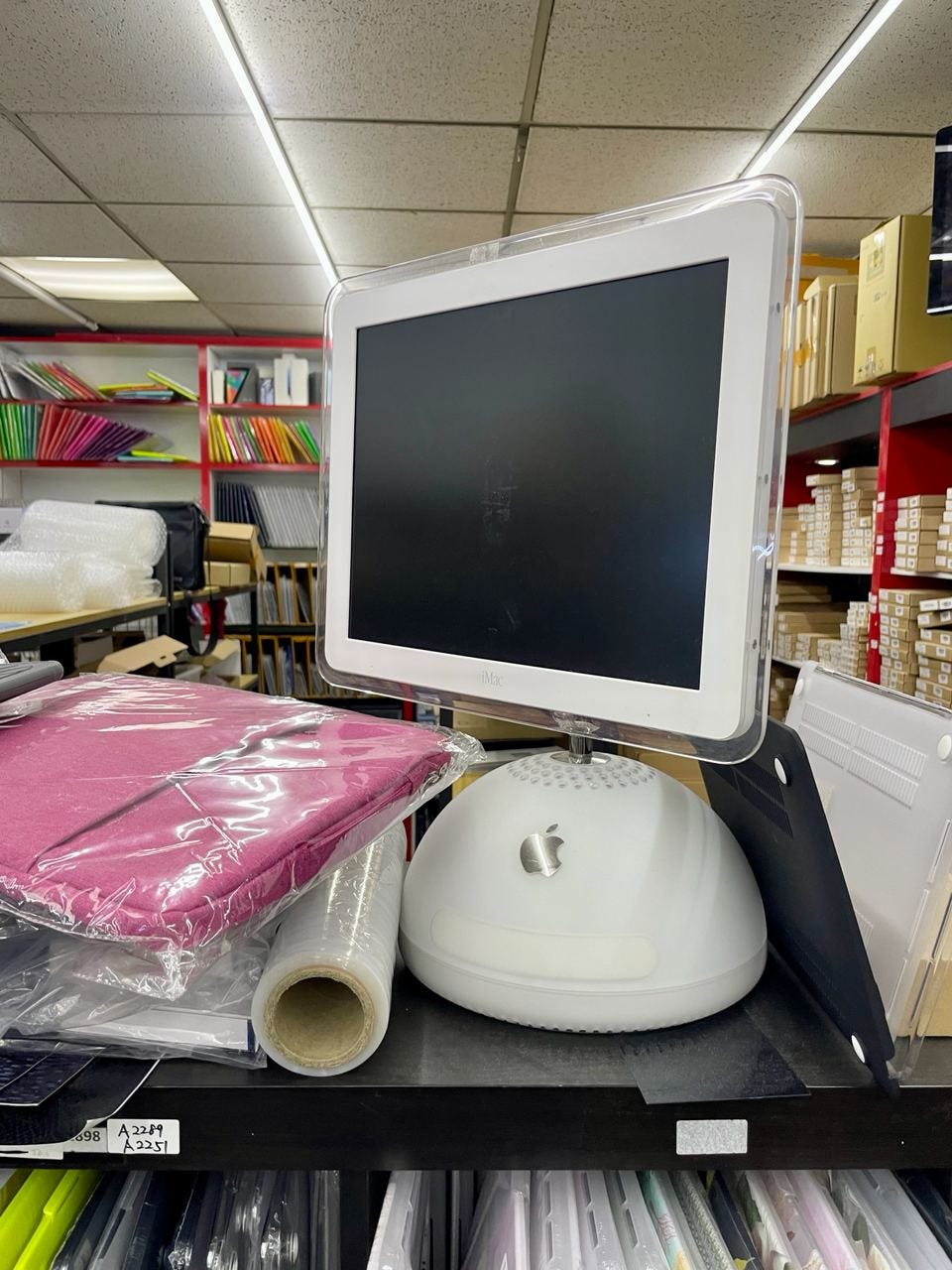 Older Apple iMac displayed in an electronics shop