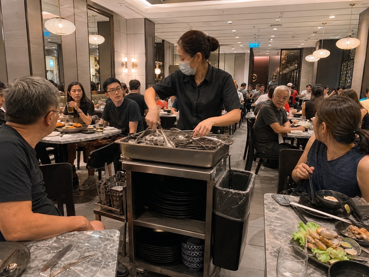 Restaurant staff sorting cutlery in the middle of the dining room
