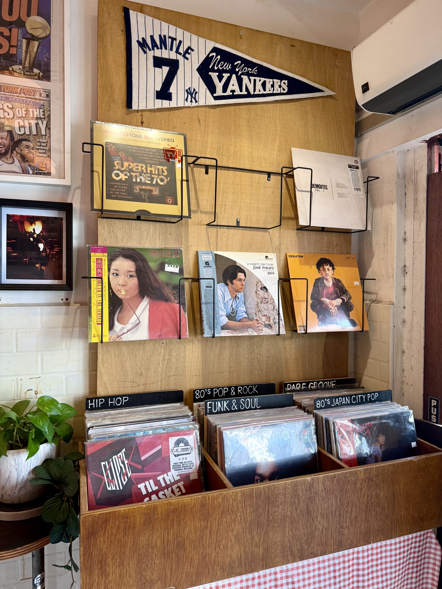 Vinyl records for sale beneath New York Yankees decor at Choice Cuts