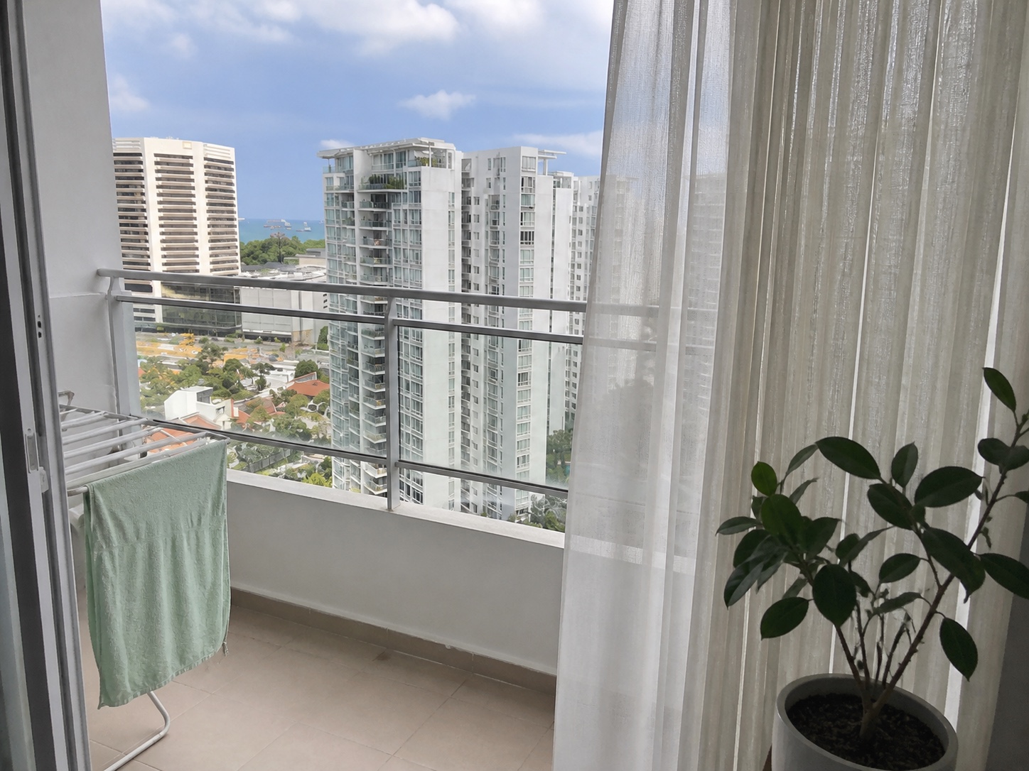 A still curtain and towel on a high-floor East Coast balcony
