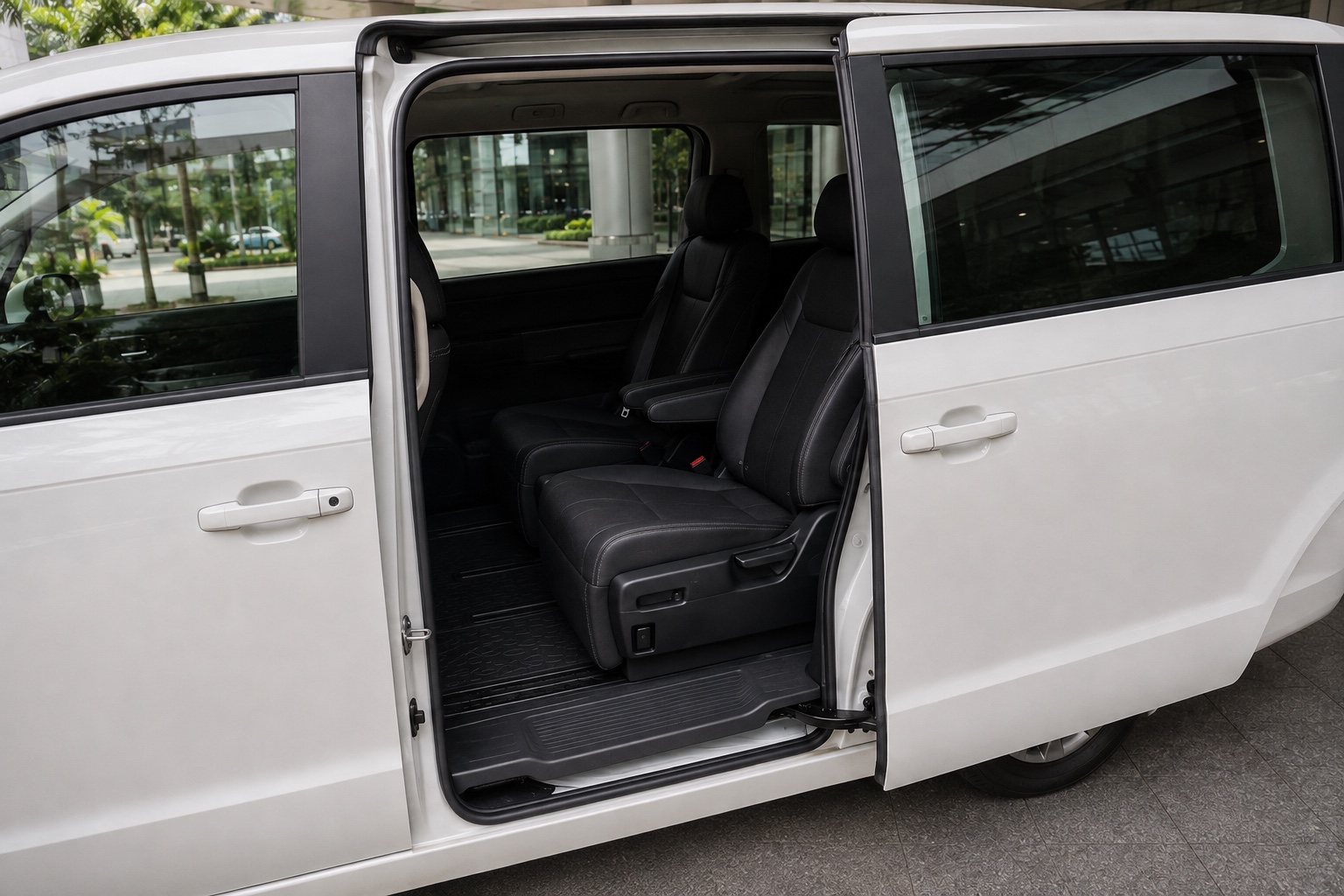 White minivan with its sliding passenger door open at a Singapore drop-off point