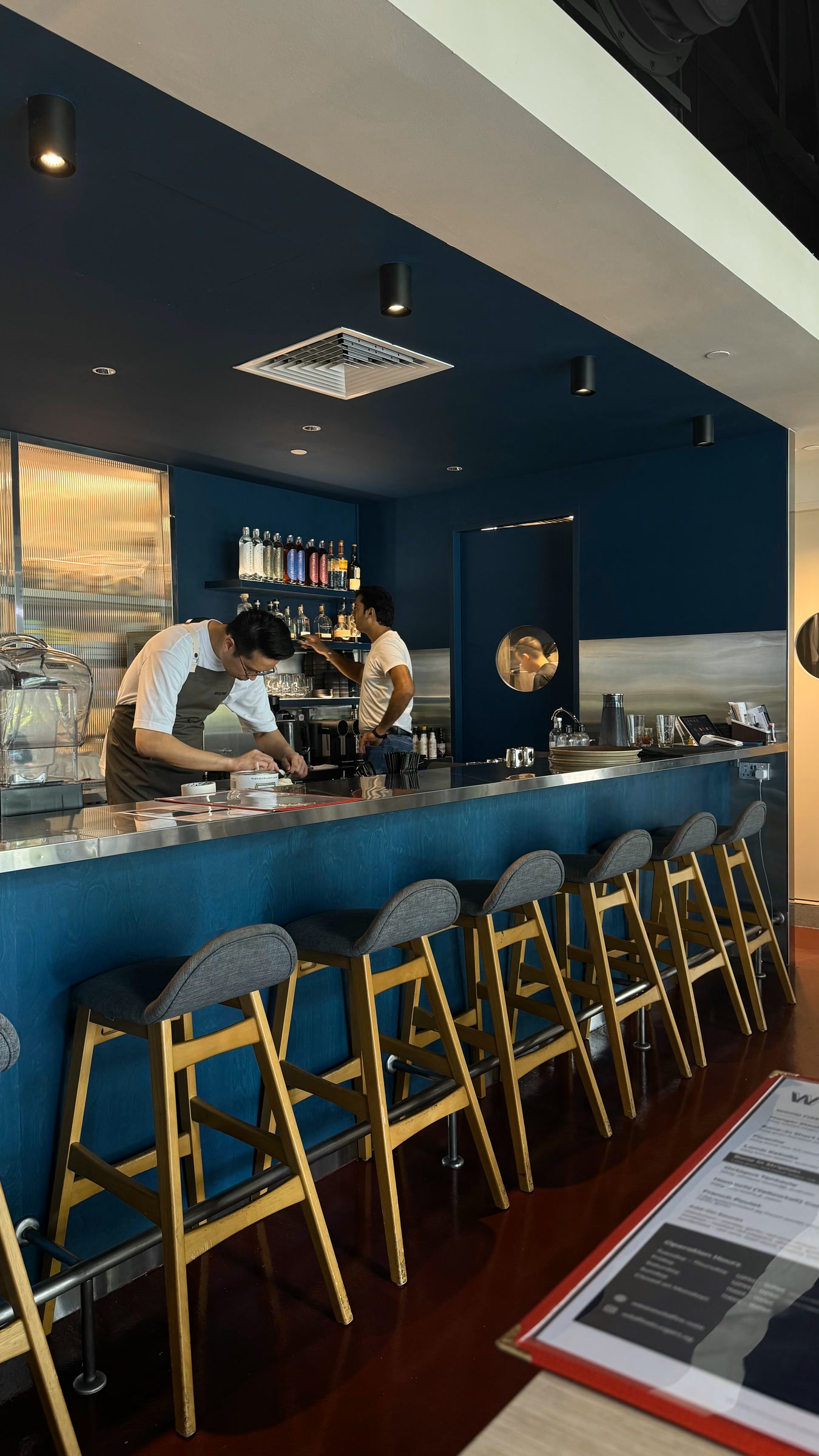 Blue bar and staff inside Wildfire at UE Square