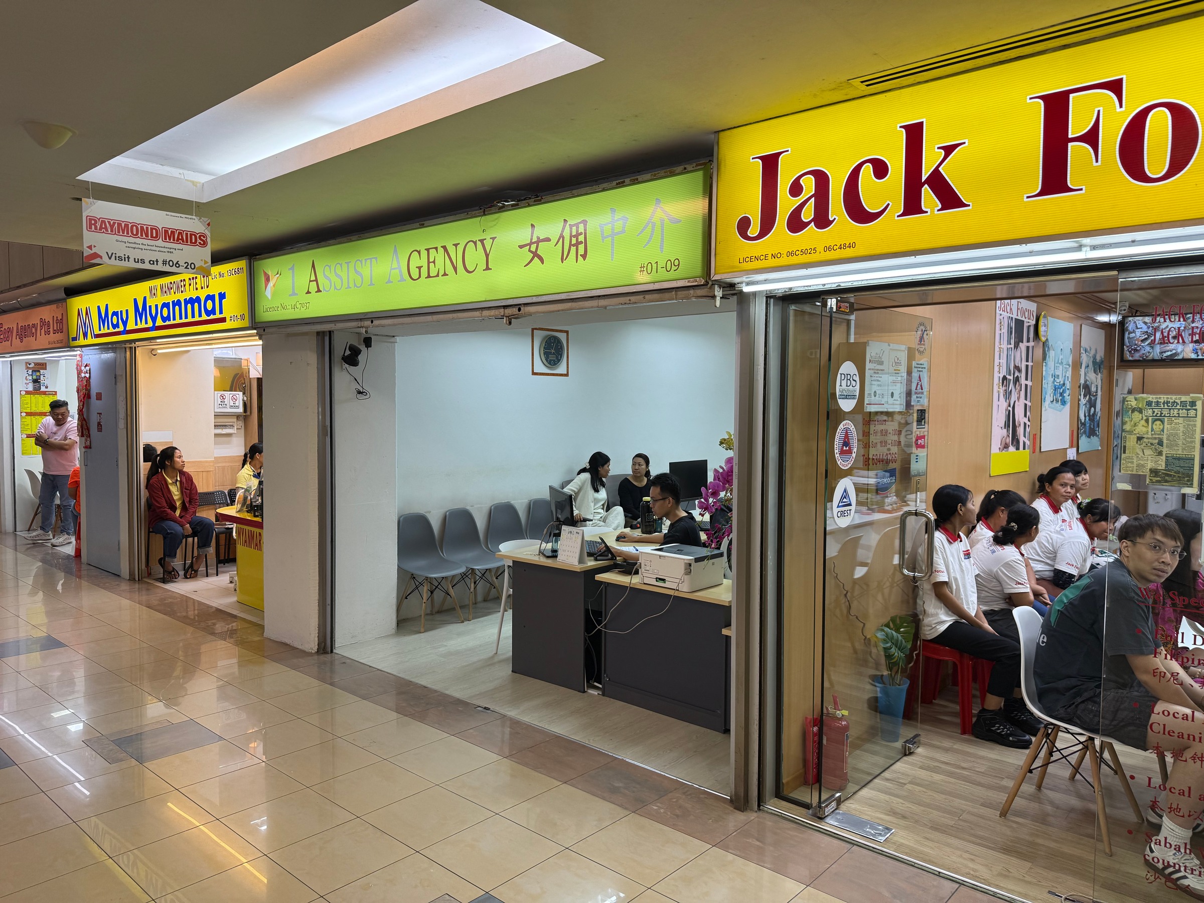 Domestic-helper agencies along a shopping-centre corridor.