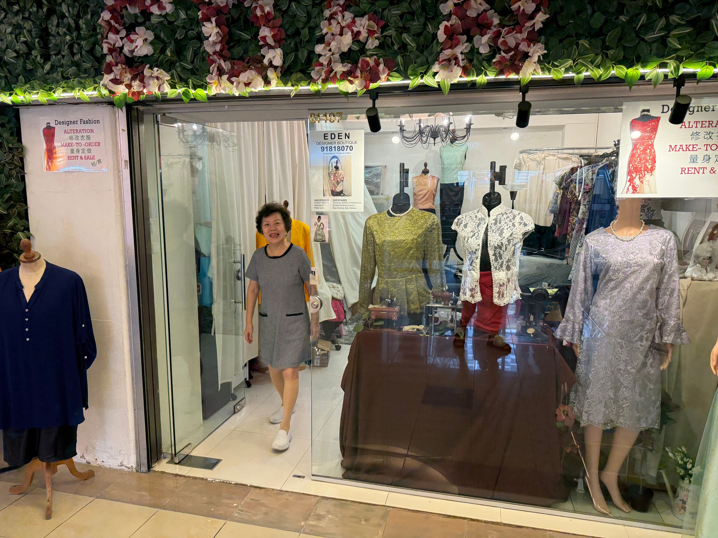 Clothes at Eden Designer Boutique, with signs advertising alterations and made-to-order work.