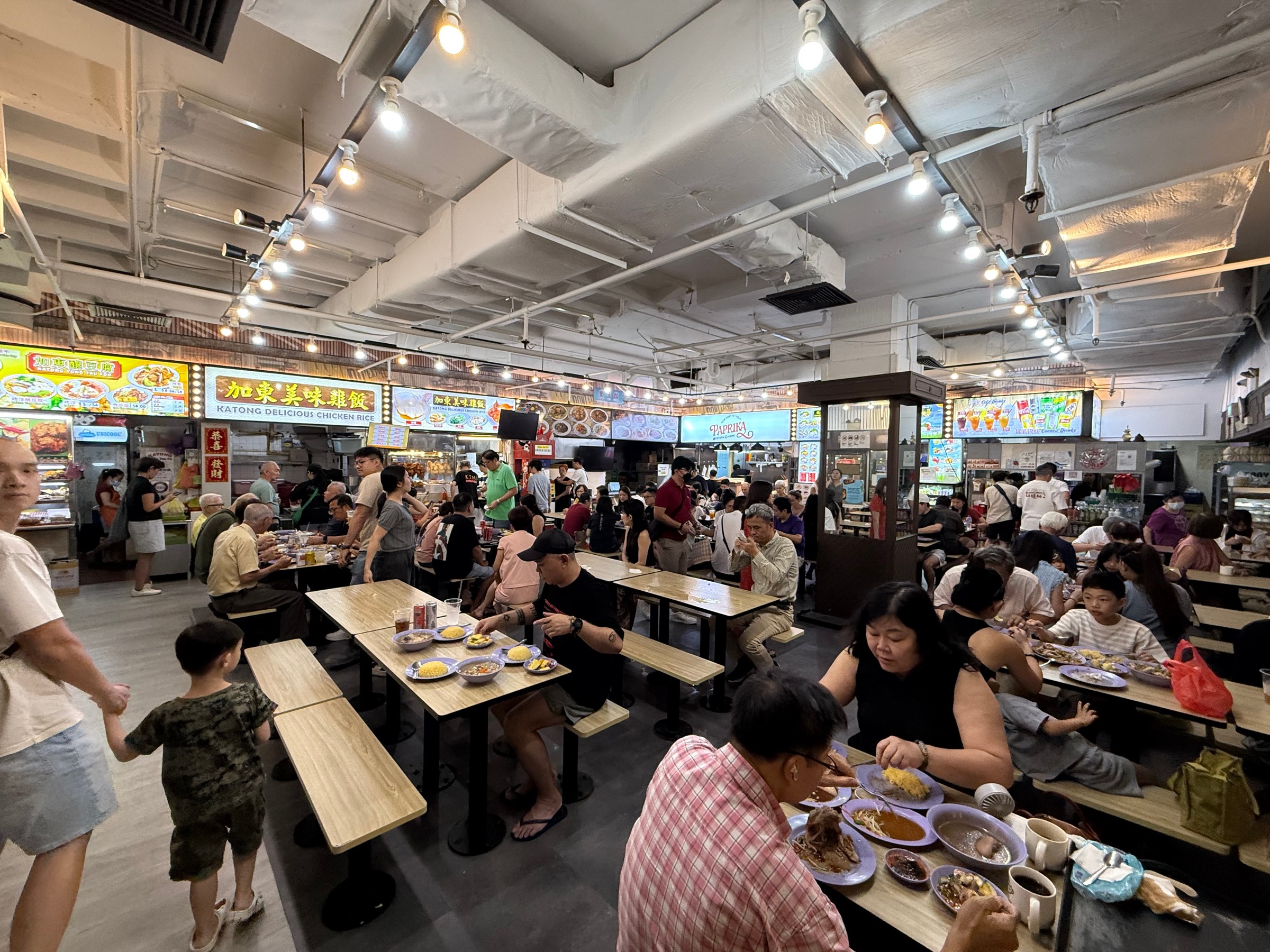 Diners filling the tables in the older food court.