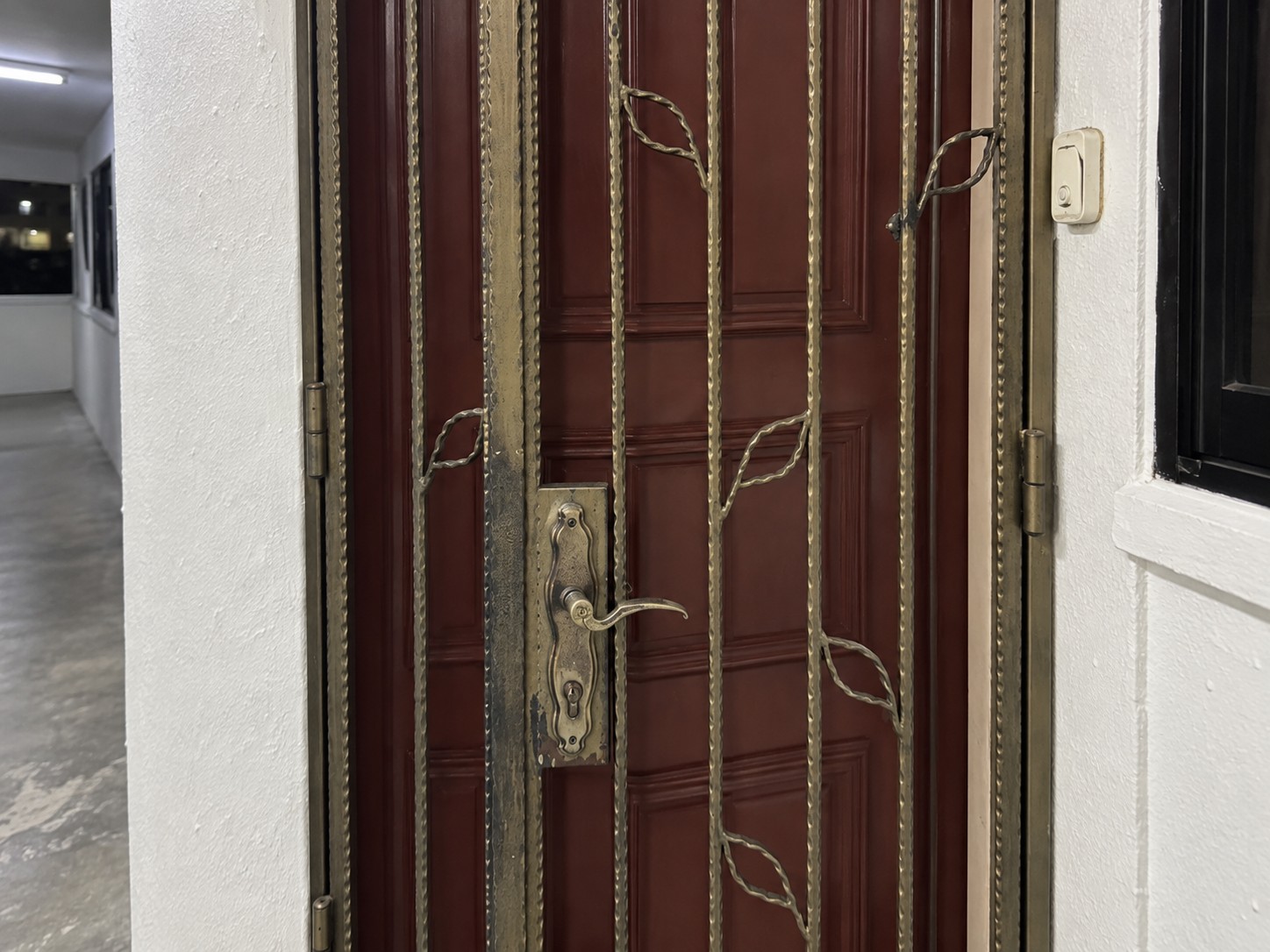 Closed metal gate at an HDB apartment entrance