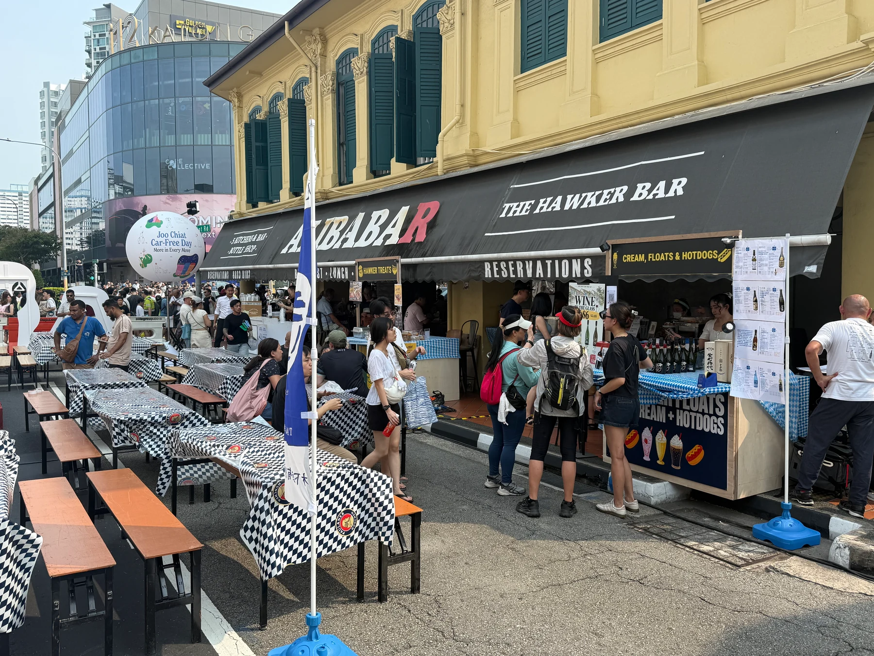 Long tables and benches on Joo Chiat Road outside Alibabar.